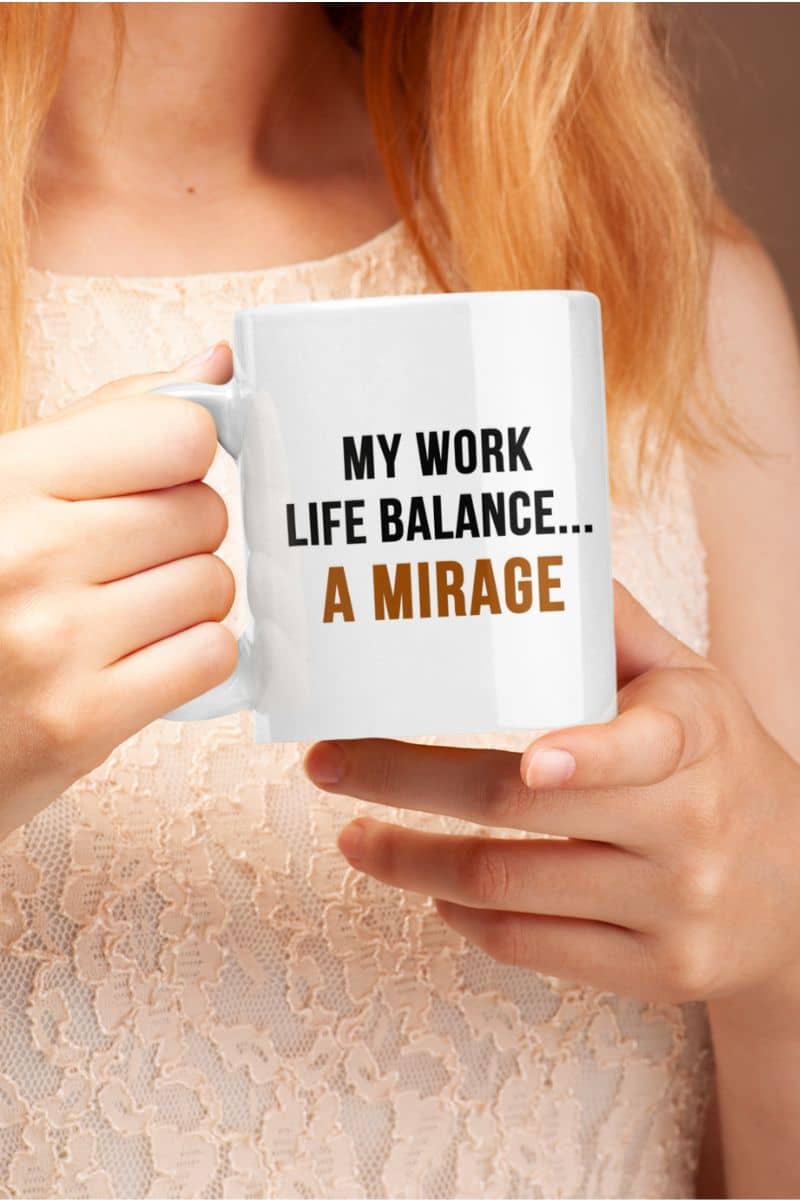 office desk mug with a person holding a mug with 'My work life balance... A mirage' text