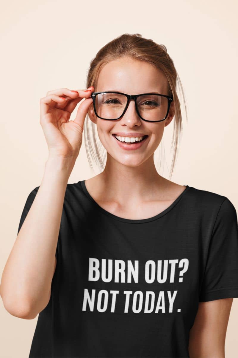 positive message t-shirt with a person wearing a black t-shirt with 'BURN OUT? NOT TODAY.' text on a beige background