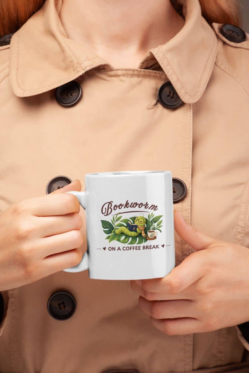 reader coffee mug with a person holding a white ceramic mug featuring the text 'Bookworm ON A COFFEE BREAK'.