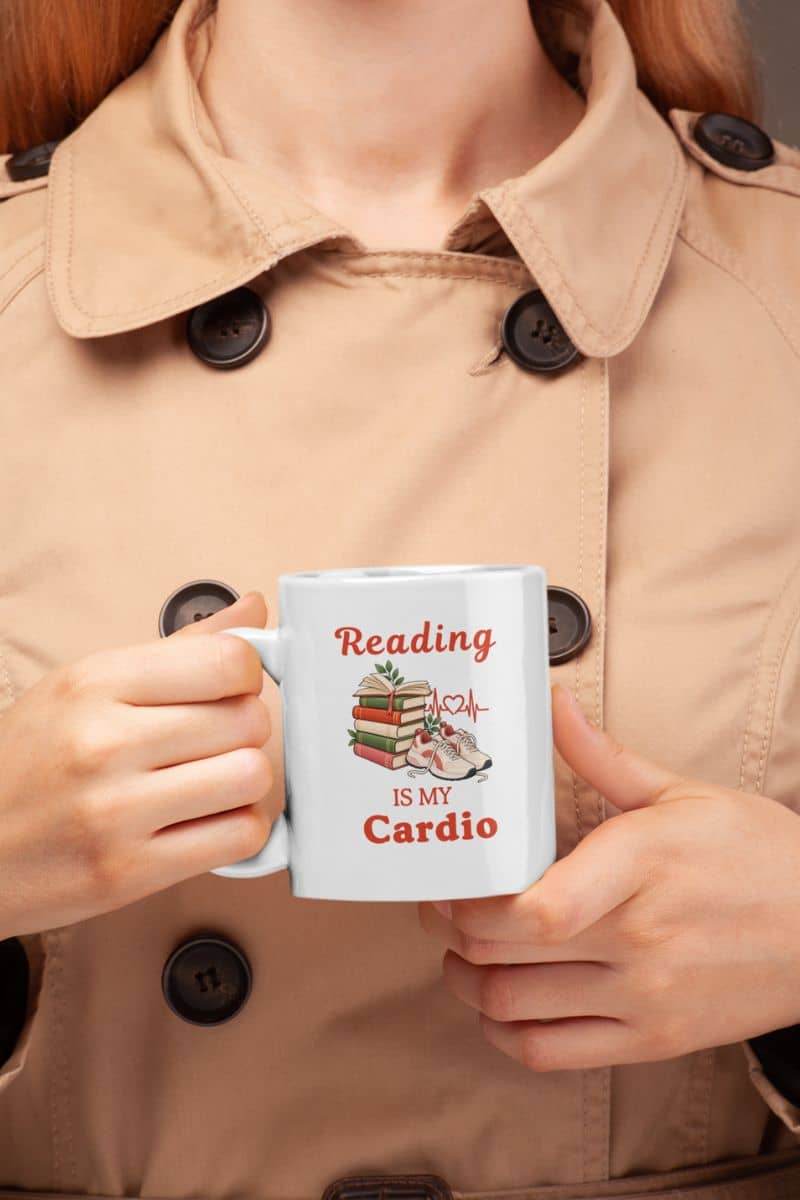 reading coffee mug with a person holding a white ceramic mug that reads 'Reading is my Cardio' 