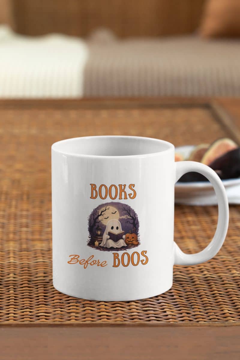 reading mug with a mug featuring the text 'Books Before Boos'