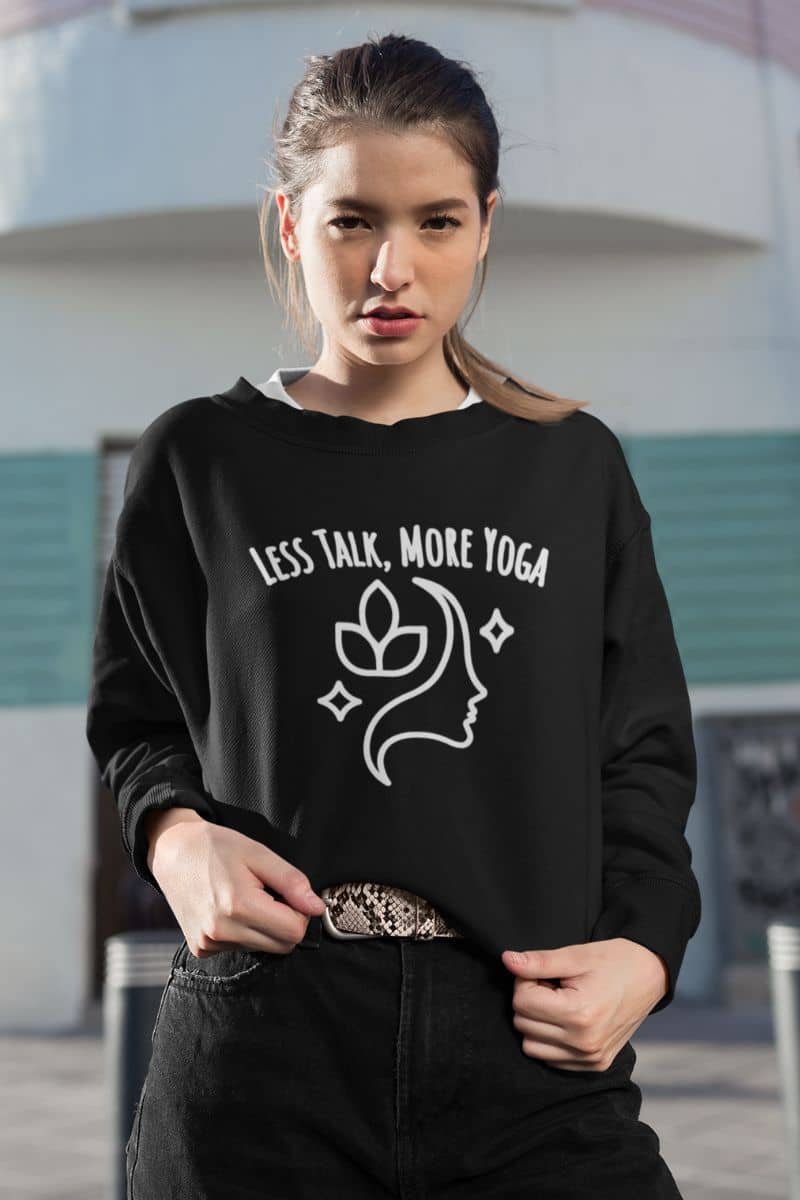relaxed yoga sweatshirt with a person wearing a black sweatshirt with 'Less Talk, More Yoga' text and design.