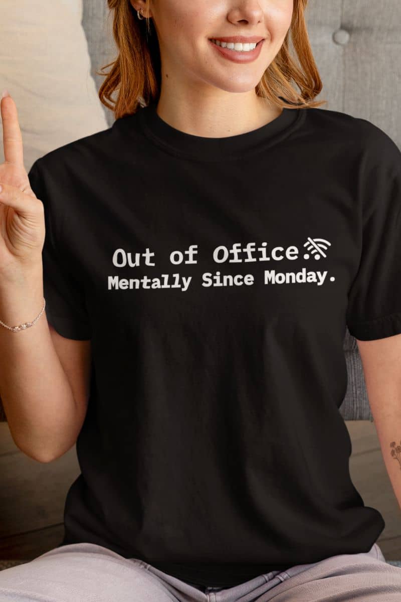 remote job humor tee with a person wearing a black t-shirt with humorous text 'Out of Office. Mentally Since Monday.'