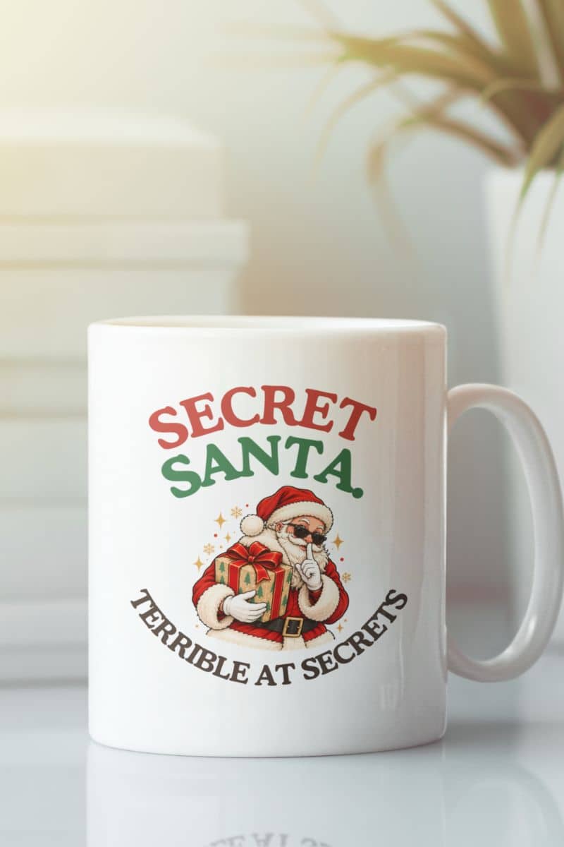 Retro Christmas mugs featuring a vintage-style Santa in sunglasses holding a wrapped gift, displayed on a white ceramic coffee mug.