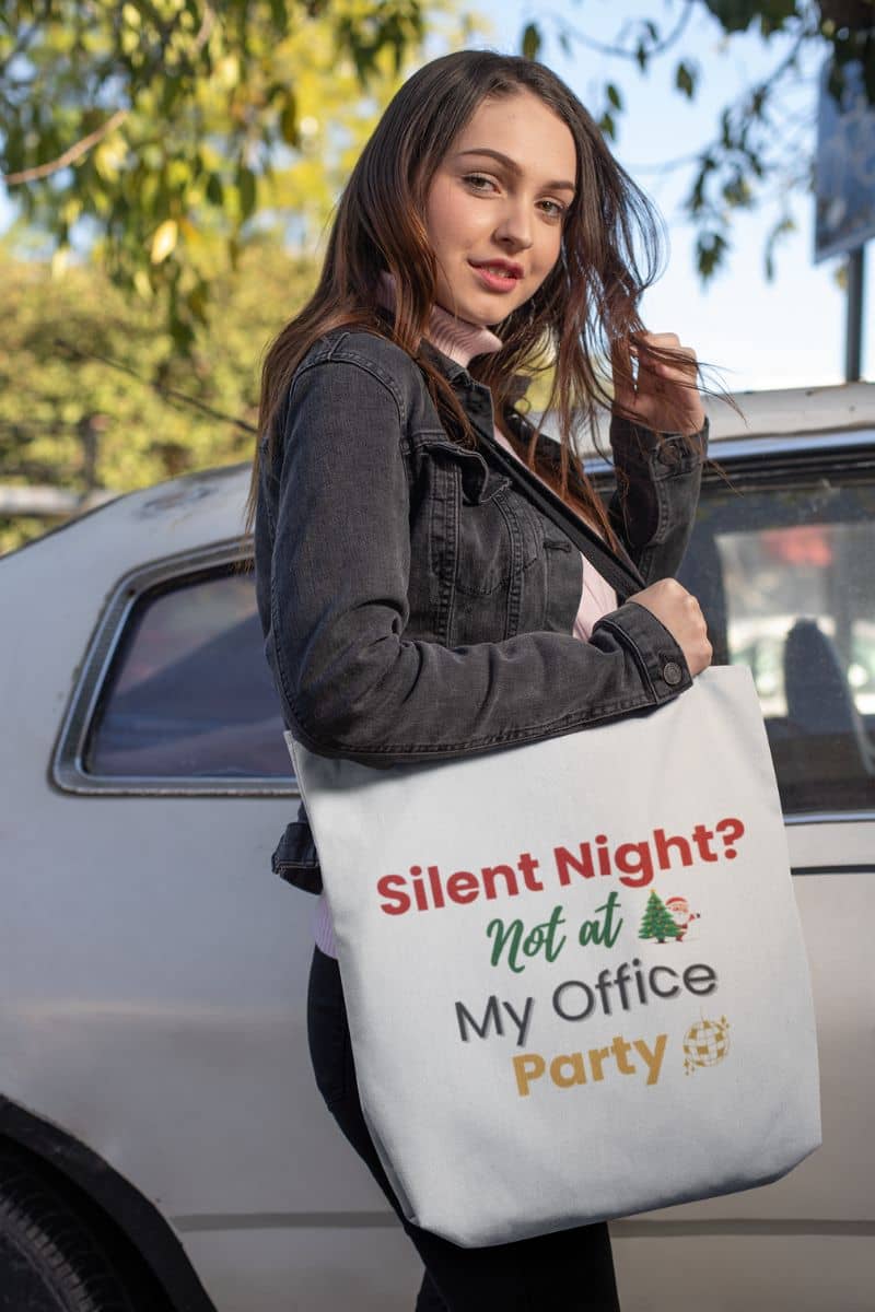 reusable gift bag with a woman holding a tote bag with humorous text 'Silent Night? Not at My Office Party' in front of a car