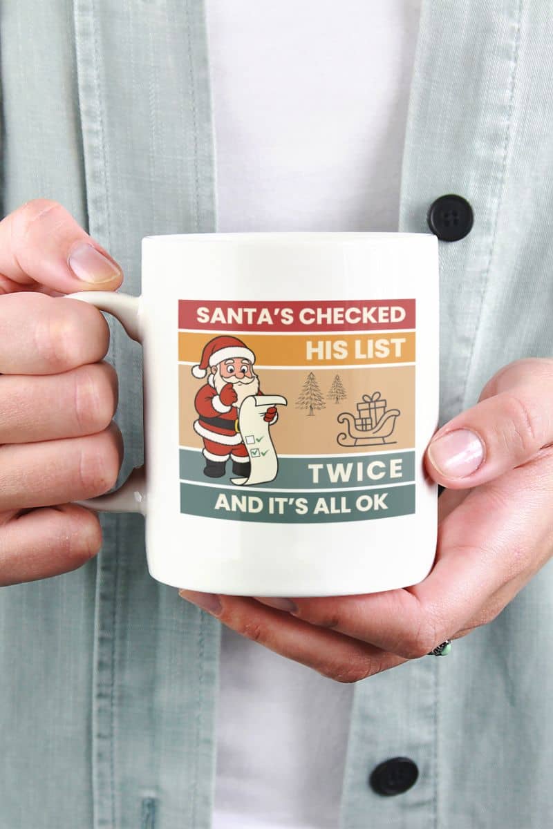 santa coffee lover gift with a person holding a mug with text 'Santa's Checked His List Twice And It's All Ok'