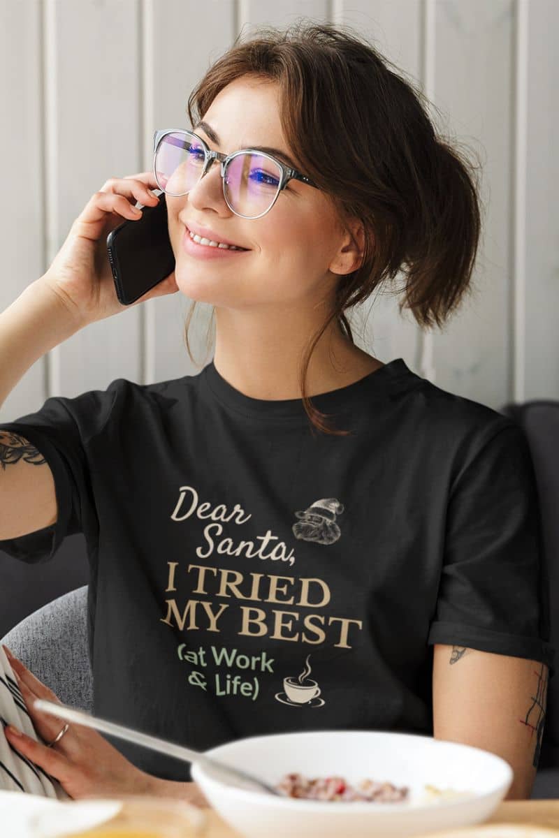 sarcastic christmas tee with a woman wearing a black t-shirt with a humorous message, sitting at a table with a bowl of cereal.