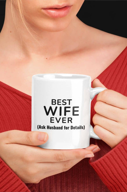 sarcastic coffee mugs with a person holding a white mug with text 'BEST WIFE EVER (Ask Husband for Details)'