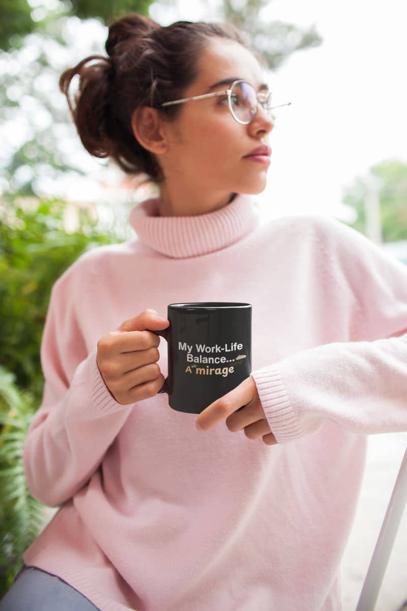 sarcastic motivational mug with a woman in pink sweater holding a black mug with text