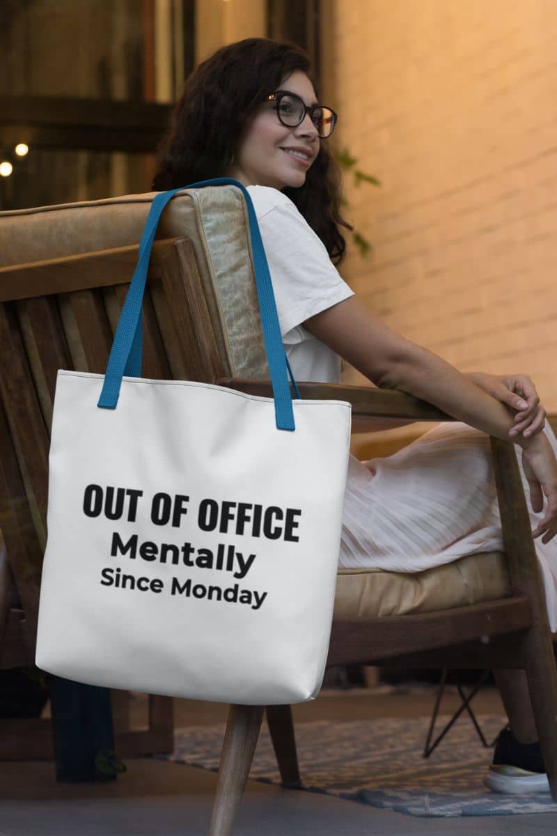 sarcastic office bag with a tote bag featuring the text 'Out of Office. Mentally Since Monday.', hanging on the chair