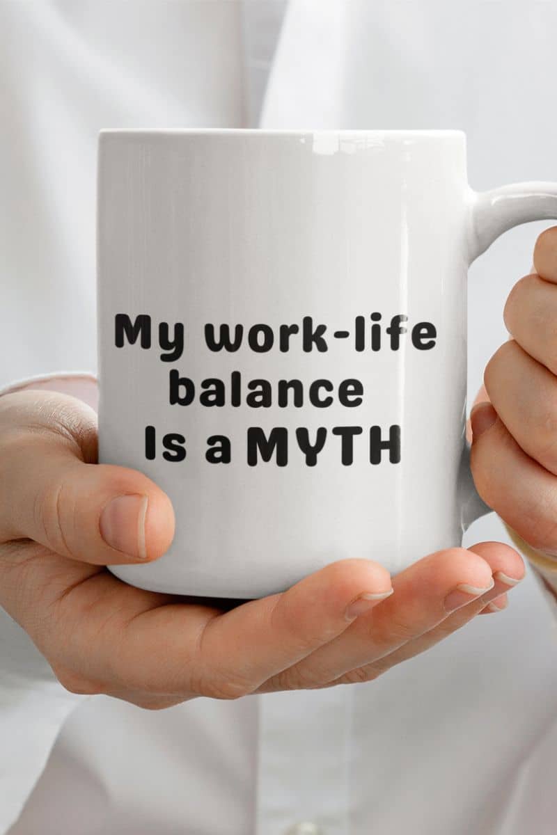 sarcastic office mug with a person holding a white mug with 'My work-life balance is a myth' text.
