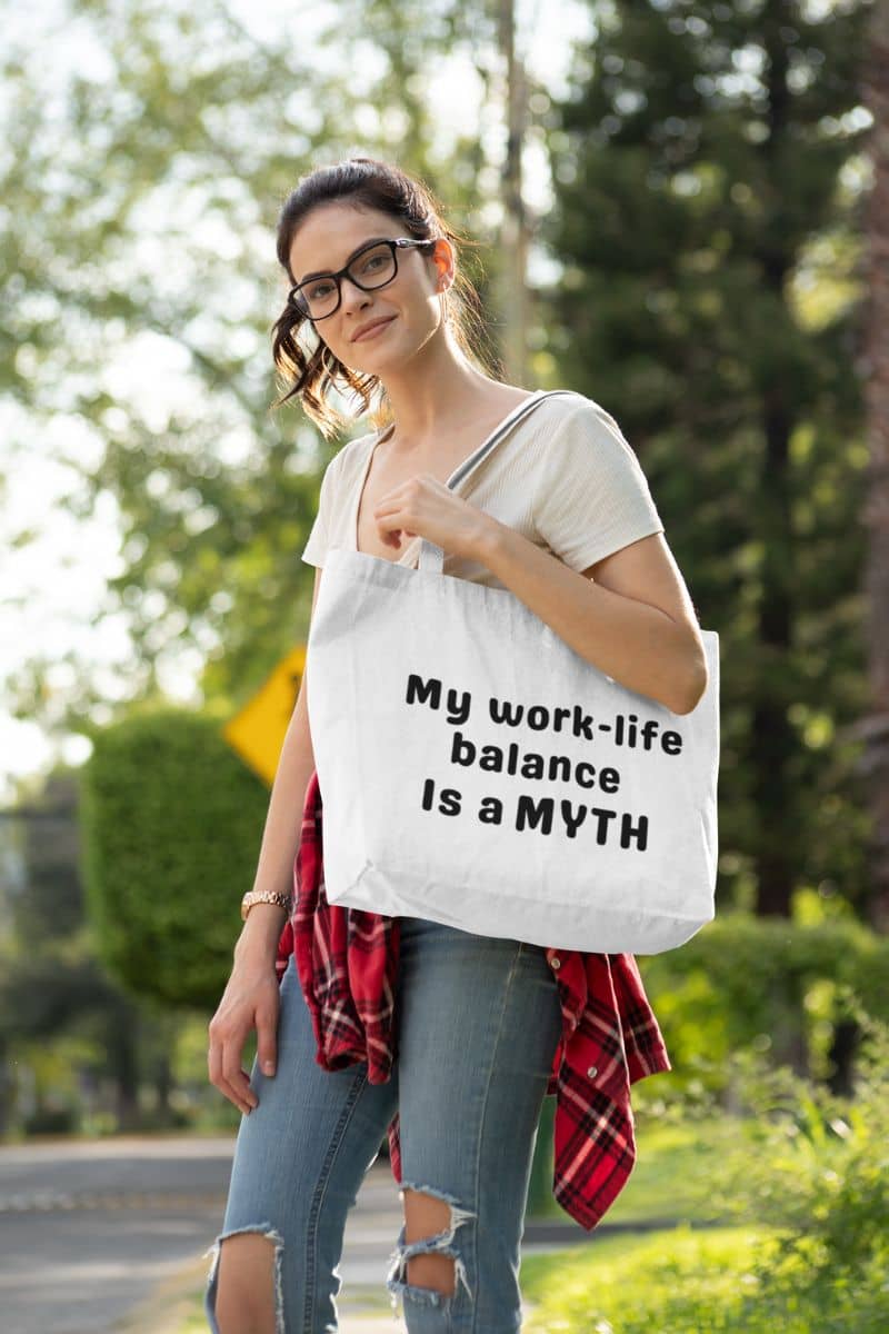 sarcastic work tote with a woman holding a tote bag with text 'My Work-Life Balance Is a Myth' outdoors