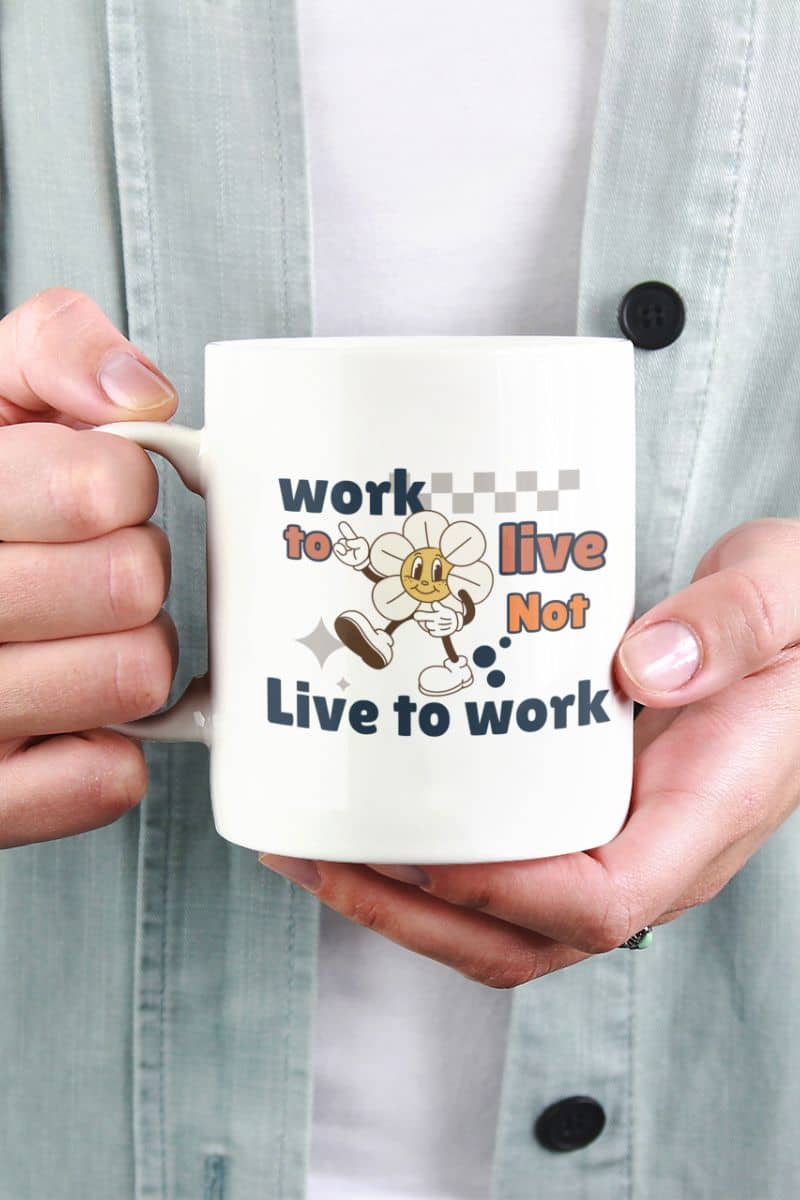 self care coffee mug with a person holding a mug with a motivational quote 'Work to Live, Not Live to Work' and cartoon character.