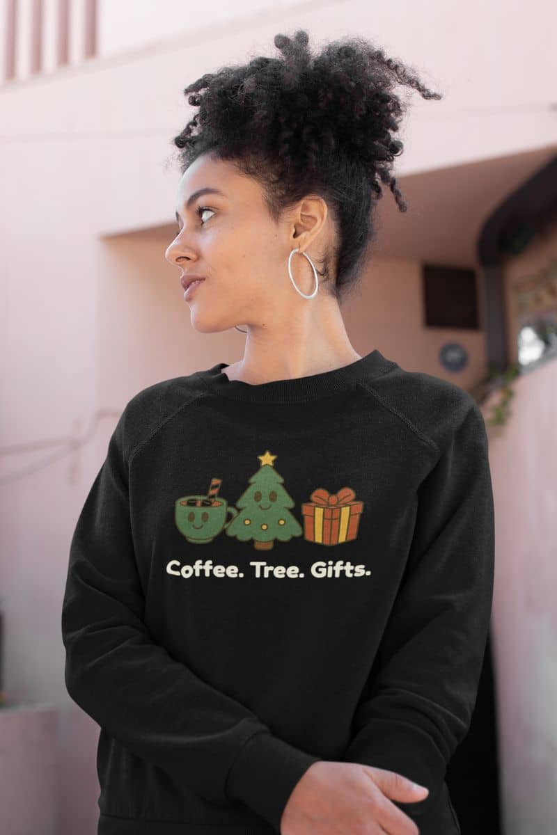 simple holiday sweater with a person wearing a black sweatshirt with Christmas-themed design and text.