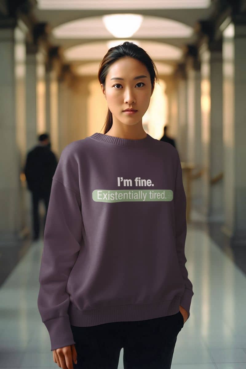 snarky oversized sweatshirt with a person wearing a purple sweater with text 'I’m fine. Just existentially tired' in a hallway