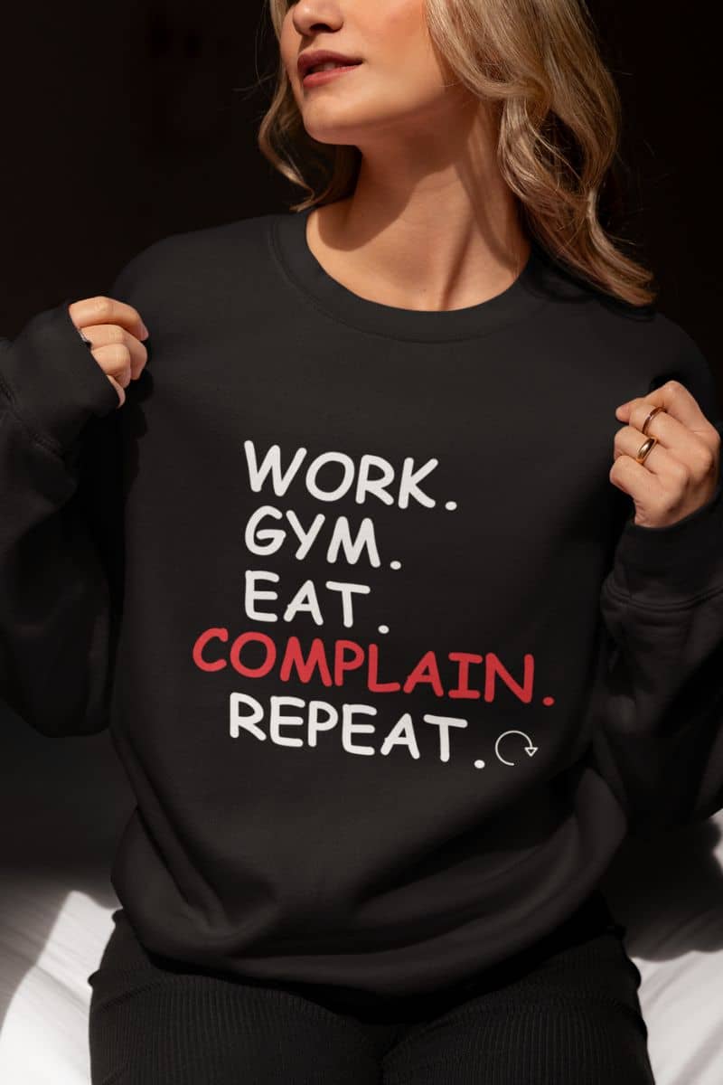 soft fleece sweatshirt with a person wearing a black sweatshirt with text 'WORK. GYM. EAT. COMPLAIN. REPEAT.'