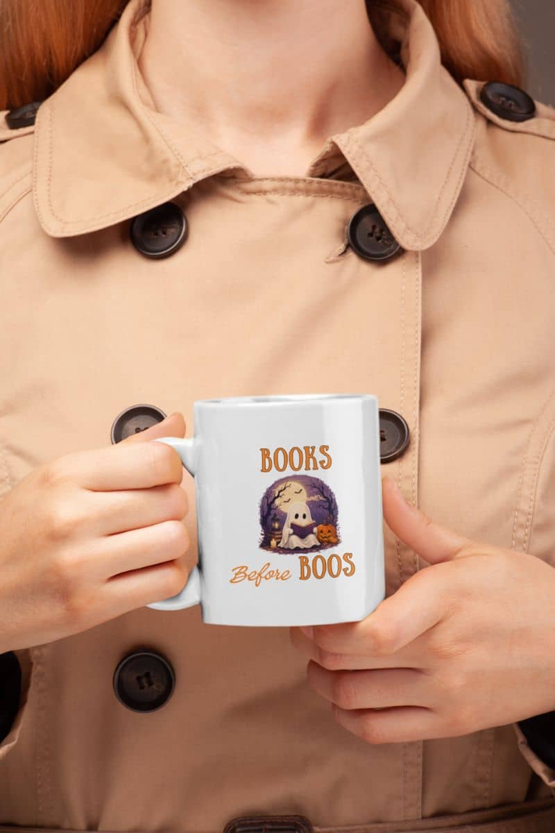 spooky mug with a person holding a mug featuring the text 'Books Before Boos'