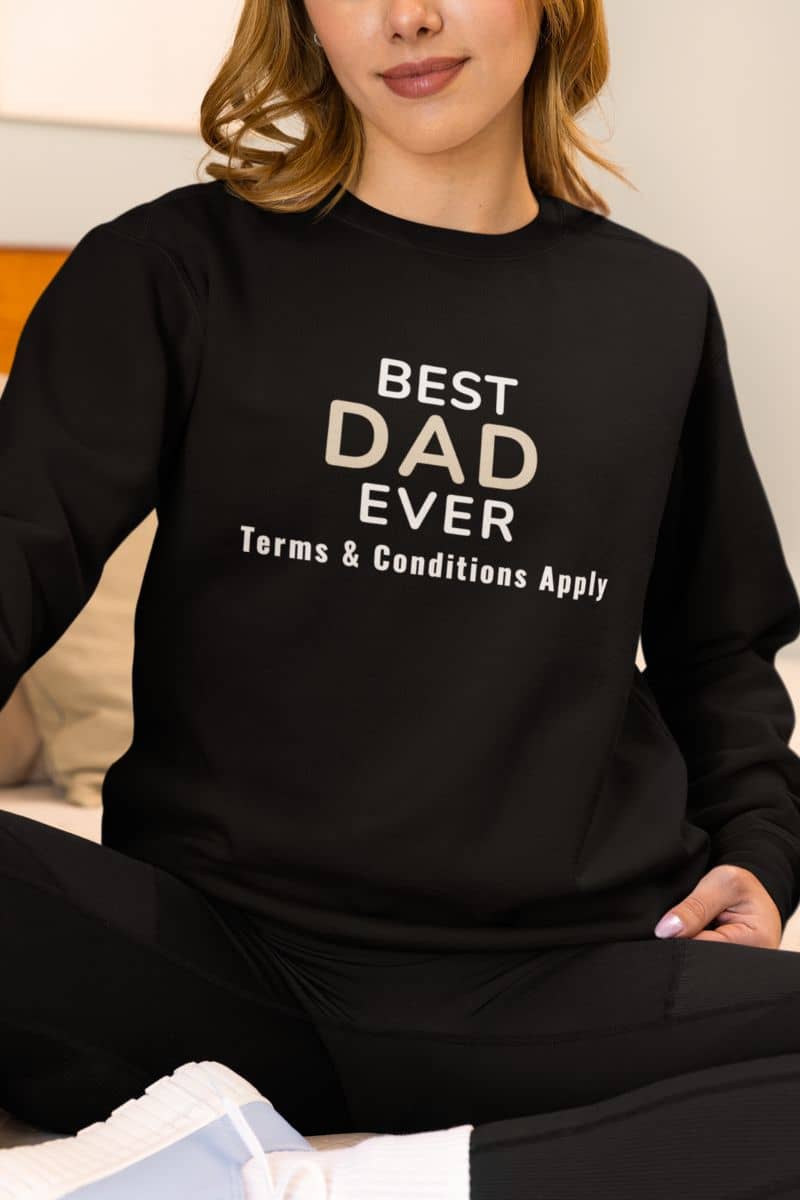 sweater for dad with a person wearing a black sweatshirt with 'Best Dad Ever, Terms & Conditions Apply' text.