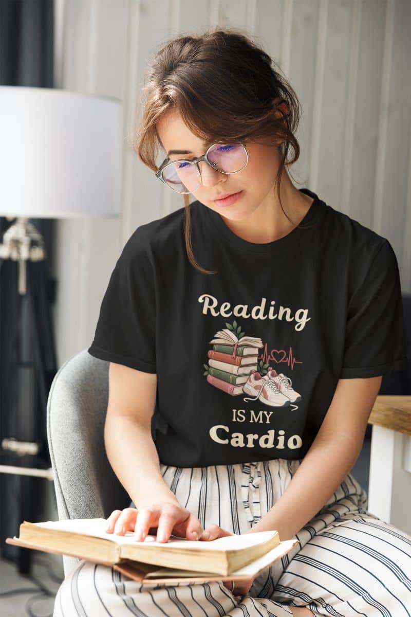 t shirts for book lovers with a woman wearing a t-shirt featuring the text 'Reading is my Cardio', reading book