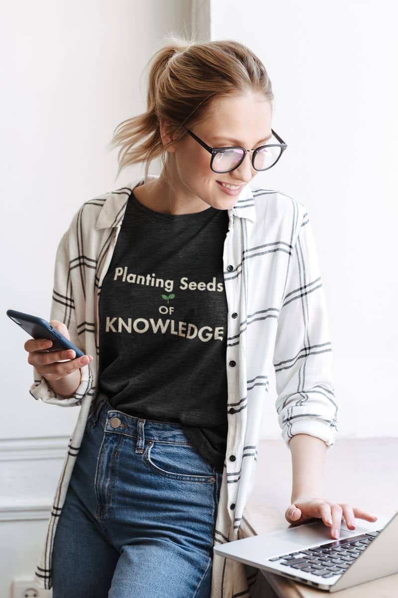teacher t shirt with a woman wearing a t-shirt featuring the text 'Planting Seeds of KNOWLEDGE' 