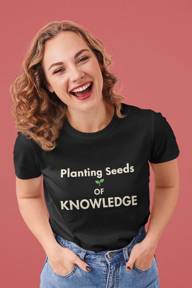 teacher tee with a woman wearing a black t-shirt that reads 'Planting Seeds OF KNOWLEDGE' 