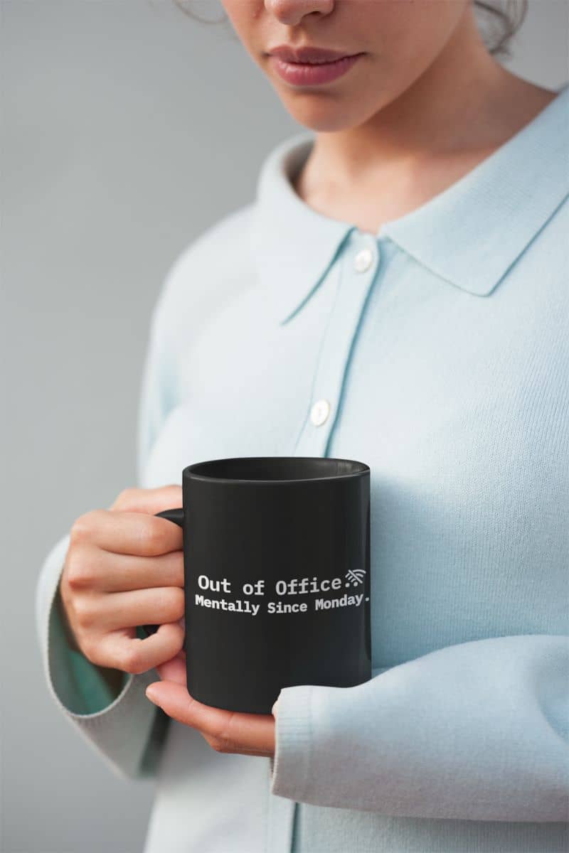 therapy in a mug with a person holding a black mug with text, wearing a light blue shirt against a gray background