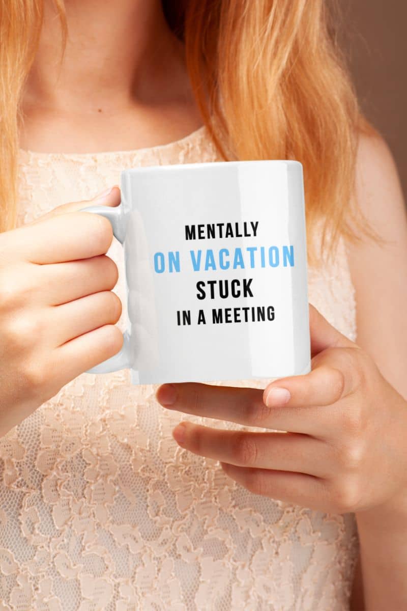 vacation mug with a person holding a mug with 'Mentally on vacation, stuck in a meeting' text