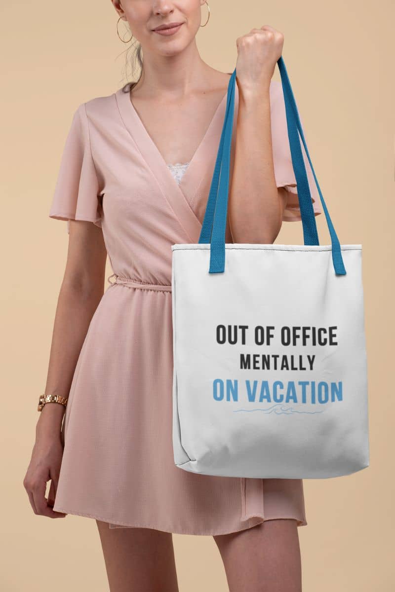 vacation tote bag with a woman holding a tote bag with text 'Out of Office Mentally On Vacation' against a beige background