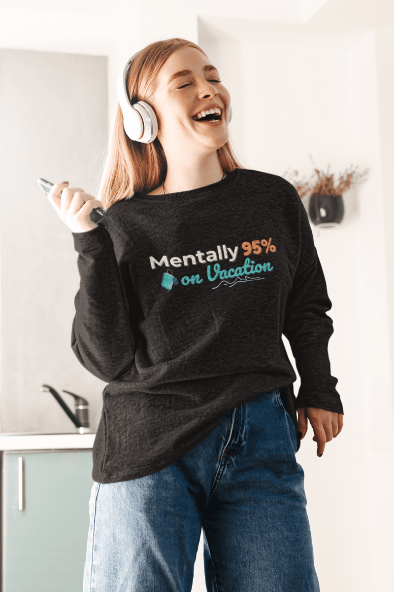 wanderlust sweatshirt with a person wearing a black sweatshirt with 'Mentally 95% on Vacation' text, laughing and holding a phone.