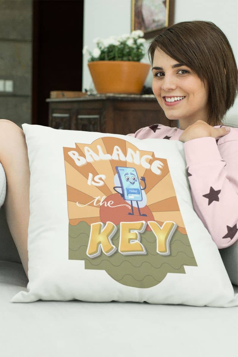 wellness meditation pillow with a woman holding a pillow with 'Balance is the Key' design
