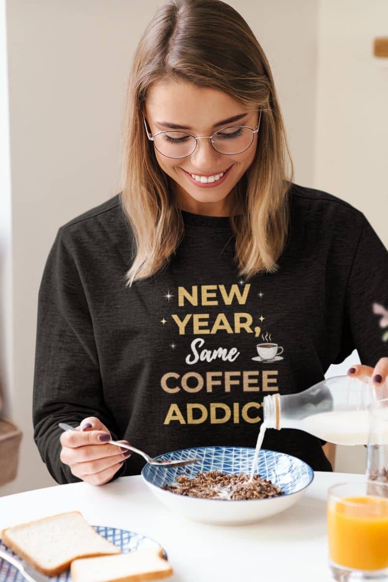 winter comfy pullover with a woman in a black sweatshirt featuring the text 'New Year, Same Coffee Addict'