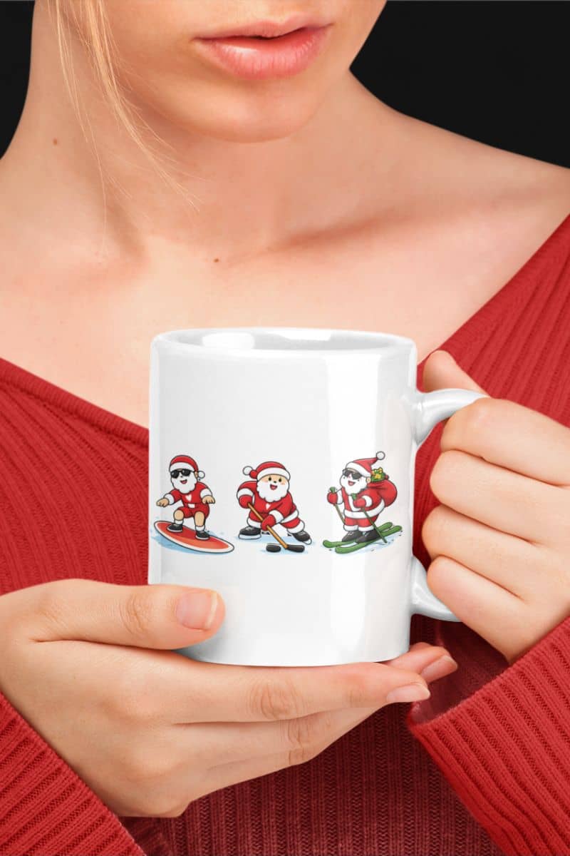 winter sports christmas mug with a person holding a white mug with Santa Claus illustrations on a black background