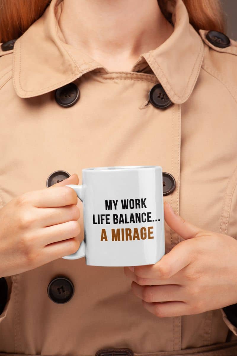 work stress mug with a person holding a mug with text 'My Work-Life Balance Is a Mirage' against a neutral background