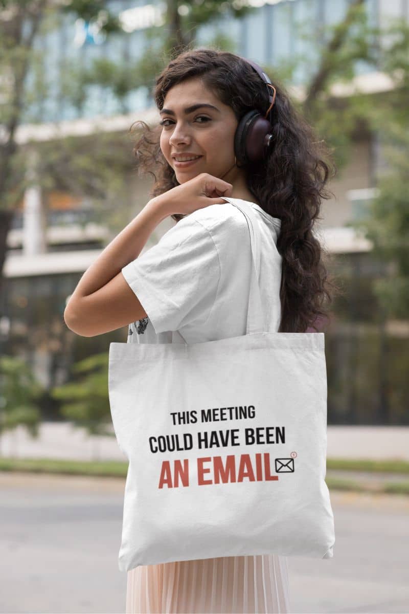 work tote bag with a woman wearing headphones and holding a tote bag with text in an urban setting