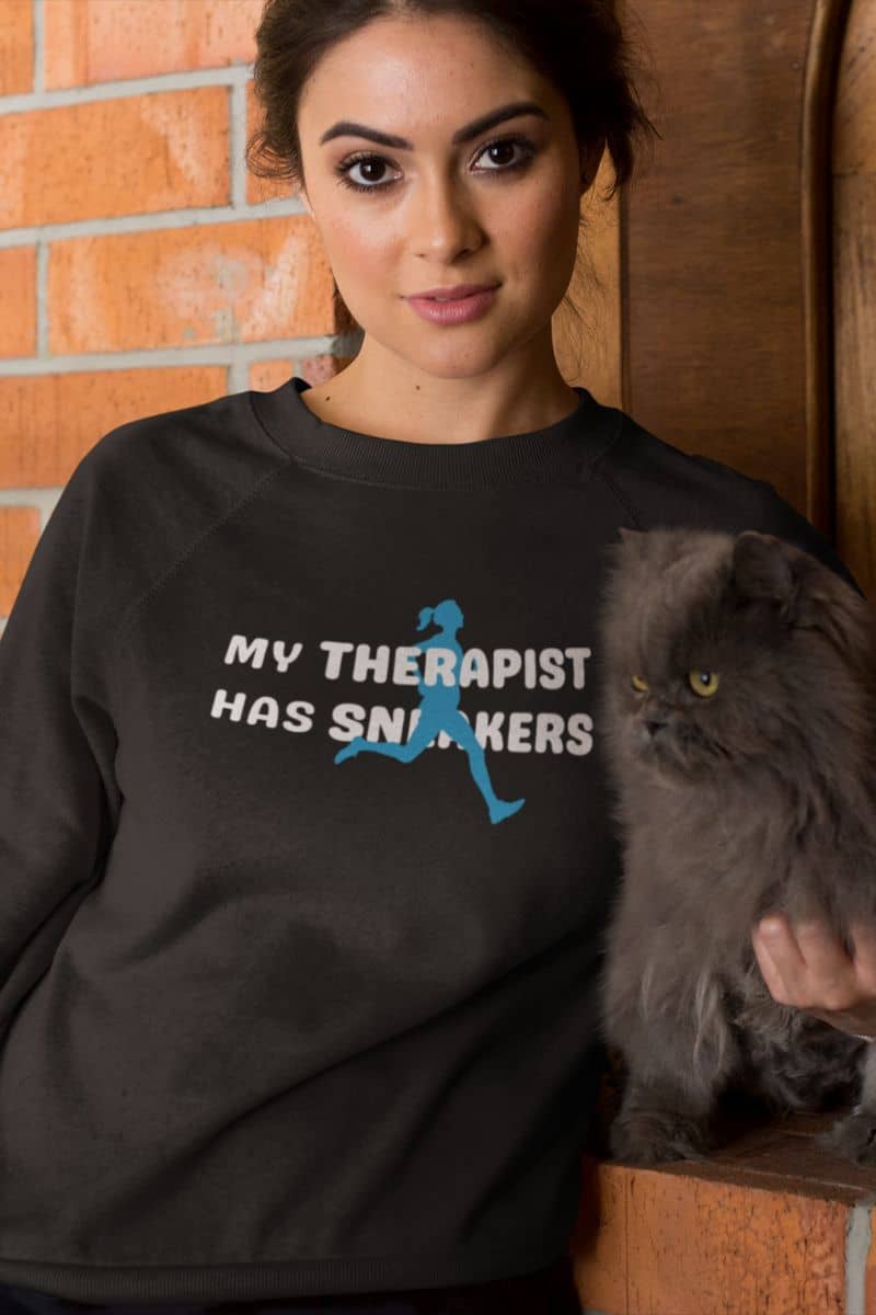 workout humor sweatshirt with a person wearing a black sweatshirt with a graphic and text, holding a gray cat.