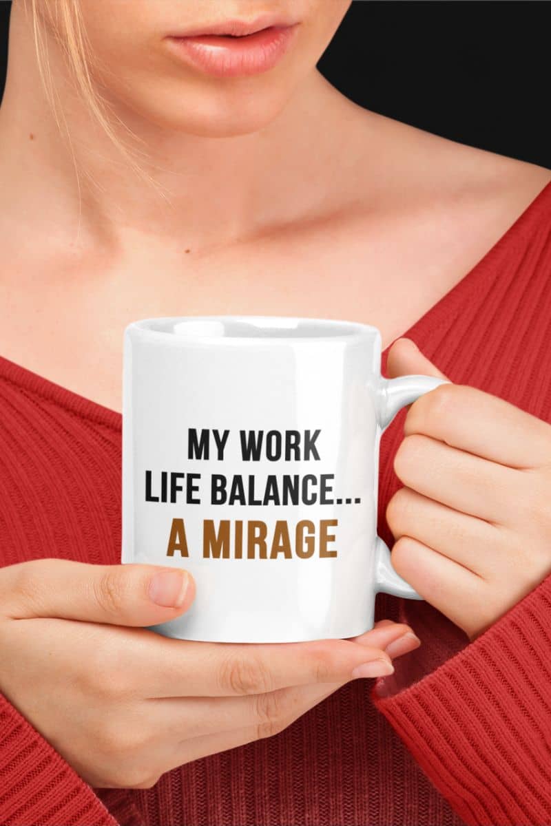 workplace coffee mug with a person holding a mug with 'My work life balance... A mirage' text